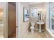 Bathroom featuring pedestal sink, toilet, window, and walk in shower at 2070 W Lake Hamilton Dr, Winter Haven, FL 33881