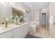 Bathroom featuring double vanity, soaking tub, and decorative floral arrangement at 2070 W Lake Hamilton Dr, Winter Haven, FL 33881