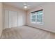Bright bedroom features a ceiling fan, plush carpet, closet, and a large window offering great natural light at 2070 W Lake Hamilton Dr, Winter Haven, FL 33881