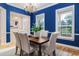 Bright dining room with hardwood floors, chandelier, and stylish blue accent wall at 2070 W Lake Hamilton Dr, Winter Haven, FL 33881