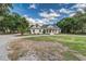 Inviting single-story home with manicured lawn and charming front porch at 2070 W Lake Hamilton Dr, Winter Haven, FL 33881