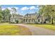 Charming single-story home with a welcoming front porch and well-manicured lawn at 2070 W Lake Hamilton Dr, Winter Haven, FL 33881