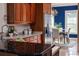 Kitchen with wood cabinetry, stainless steel appliances, and view to formal dining room at 2070 W Lake Hamilton Dr, Winter Haven, FL 33881