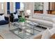 Open living room with modern decor, glass coffee table and seamless flow into dining area at 2070 W Lake Hamilton Dr, Winter Haven, FL 33881
