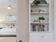 Bright built in bookcase in the living room, with an adjacent peek of a bedroom at 2070 W Lake Hamilton Dr, Winter Haven, FL 33881