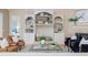 Bright living room featuring a custom built-in bookcase, fireplace, and comfortable seating at 2070 W Lake Hamilton Dr, Winter Haven, FL 33881