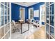 Office featuring blue walls, hardwood floors, two chairs, and lots of natural light at 2070 W Lake Hamilton Dr, Winter Haven, FL 33881
