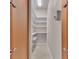 Walk-in pantry with white shelves and tiled floor provides efficient storage space at 2070 W Lake Hamilton Dr, Winter Haven, FL 33881