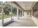 Large screened porch with multiple ceiling fans, offering an excellent space for outdoor relaxation and entertaining at 2070 W Lake Hamilton Dr, Winter Haven, FL 33881