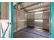 Interior view of a functional horse stall with metal siding, wooden beams, and access to the outdoors at 2070 W Lake Hamilton Dr, Winter Haven, FL 33881