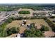 Aerial view showcases a large property nestled near a pond, a highway, and neighborhood at 2171 Sophia S Pl, Lakeland, FL 33811