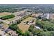 Expansive aerial view of a farm with multiple outbuildings and mature trees in a residential area at 2171 Sophia S Pl, Lakeland, FL 33811