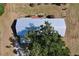 Aerial shot focusing on the metal roof and back of the house, partially obscured by a large tree at 2171 Sophia S Pl, Lakeland, FL 33811