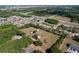 Expansive aerial view of a spacious property surrounded by a mix of trees and suburban homes at 2171 Sophia S Pl, Lakeland, FL 33811