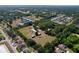 Expansive aerial view of a home and its outbuildings set within a large, green, and wooded lot at 2171 Sophia S Pl, Lakeland, FL 33811