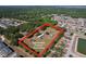 Aerial view of a property outlined in red, showing the home, outbuildings, and surrounding landscape at 2171 Sophia S Pl, Lakeland, FL 33811