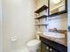 Bathroom featuring shelving, a vanity with sink, and toilet with hexagon tile flooring at 2171 Sophia S Pl, Lakeland, FL 33811