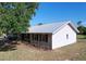 Charming home exterior with a durable metal roof and well-maintained landscaping at 2171 Sophia S Pl, Lakeland, FL 33811