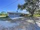 Single-story home features an attached two-car garage, front yard, and a large shade tree at 2171 Sophia S Pl, Lakeland, FL 33811