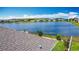 Lakeside backyard features a fence, green lawn, and mature landscaping at 2318 Rush Bay Way, Orlando, FL 32824