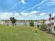 Fenced backyard with a view of the lake beyond the manicured lawn at 2318 Rush Bay Way, Orlando, FL 32824