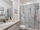 Bathroom featuring a seahorse themed shower curtain and grey stone countertop sink at 2318 Rush Bay Way, Orlando, FL 32824