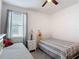 bedroom featuring two beds, a ceiling fan, and geometric decoration at 2318 Rush Bay Way, Orlando, FL 32824