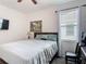 Bedroom with a bed, wood furniture and a painting hanging on the wall at 2318 Rush Bay Way, Orlando, FL 32824