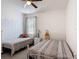 bedroom featuring two beds, a ceiling fan, and geometric decoration at 2318 Rush Bay Way, Orlando, FL 32824