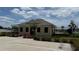 Community clubhouse, exterior view with parking, landscaping, and beautiful flowers at 2318 Rush Bay Way, Orlando, FL 32824