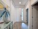 Bright foyer with tiled floors, art, and a view into other rooms at 2318 Rush Bay Way, Orlando, FL 32824
