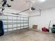 Attached two car garage with concrete floor and white walls and ceiling at 2318 Rush Bay Way, Orlando, FL 32824