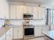 Kitchen featuring granite countertops, stainless steel appliances, and white backsplash at 2318 Rush Bay Way, Orlando, FL 32824
