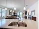Kitchen with granite countertops and breakfast bar overlooking the dining and living rooms at 2318 Rush Bay Way, Orlando, FL 32824