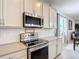Bright kitchen features white cabinets, stainless steel appliances and subway tile backsplash at 2318 Rush Bay Way, Orlando, FL 32824