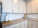 Bright kitchen features white cabinets, countertops and subway tile backsplash at 2318 Rush Bay Way, Orlando, FL 32824