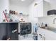 Utility room featuring a washing machine, dryer, laundry sink, and white cabinets at 2318 Rush Bay Way, Orlando, FL 32824
