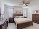 Main bedroom with bed, dresser, ceiling fan, carpet and natural light at 2318 Rush Bay Way, Orlando, FL 32824