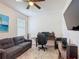 Office with gray sofa, desk, computer, and gray carpet at 2318 Rush Bay Way, Orlando, FL 32824