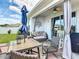 Outdoor seating on a brick patio with ceiling fan, curtains, and outdoor dining at 2318 Rush Bay Way, Orlando, FL 32824