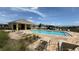 Community pool features lounge chairs, a covered area, and a beautiful view at 2318 Rush Bay Way, Orlando, FL 32824