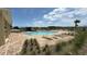 Community pool offers lounge chairs, beautiful water, and relaxing area at 2318 Rush Bay Way, Orlando, FL 32824