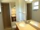 Bathroom featuring double sinks with vanities and a shower room enclosed with glass at 255 S Pennsylvania Ave, Lake Alfred, FL 33850