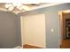Bedroom featuring hardwood floors, a ceiling fan, a built-in closet, and light-gray walls at 255 S Pennsylvania Ave, Lake Alfred, FL 33850