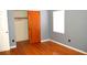 Bedroom featuring hardwood floors, light-gray walls, one window, and a closet with sliding doors at 255 S Pennsylvania Ave, Lake Alfred, FL 33850
