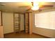 Bedroom with tiled floors, a ceiling fan, natural light, and a closet featuring shelves at 255 S Pennsylvania Ave, Lake Alfred, FL 33850