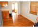 Bright dining room featuring hardwood floors, a window, and access to other rooms at 255 S Pennsylvania Ave, Lake Alfred, FL 33850