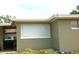 Side view of a cozy home featuring neutral siding and an attached carport at 255 S Pennsylvania Ave, Lake Alfred, FL 33850