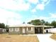 Charming single-story home with a covered carport and well-lit entry, perfect for easy access and curb appeal at 255 S Pennsylvania Ave, Lake Alfred, FL 33850