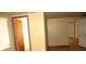 Hallway featuring tile floors, neutral walls, and multiple doors, providing access to different rooms at 255 S Pennsylvania Ave, Lake Alfred, FL 33850
